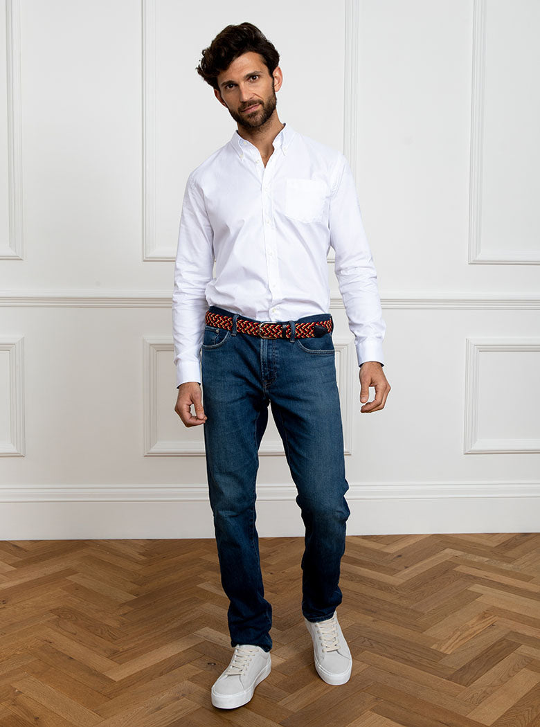 Man wearing a hand woven belt, braided and handmade in Italy with the Newmarket signature colours (gold, tan, navy) and a stretch design.