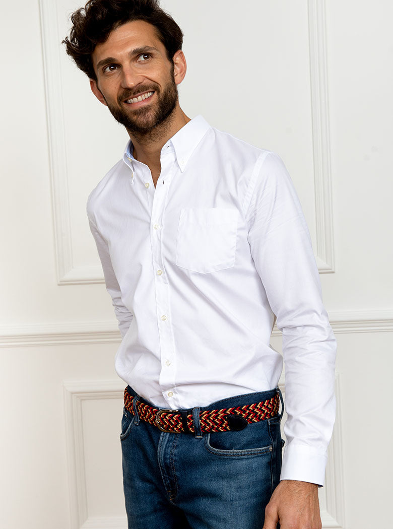 Man wearing a hand woven belt, braided and handmade in Italy with the Newmarket signature colours (gold, tan, navy) and a stretch design.