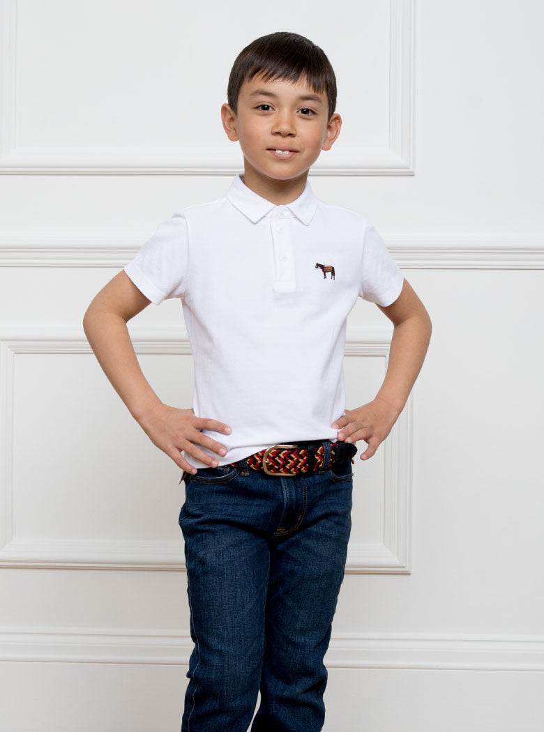 Child wearing a hand woven belt, braided and handmade in Italy with the Newmarket signature colours (gold, tan, navy) and a stretch design.