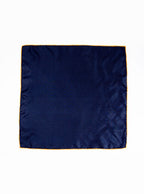 Flat lay of 100% silk 40x40 hank scarf in navy with gold yellow hand stitched border. 