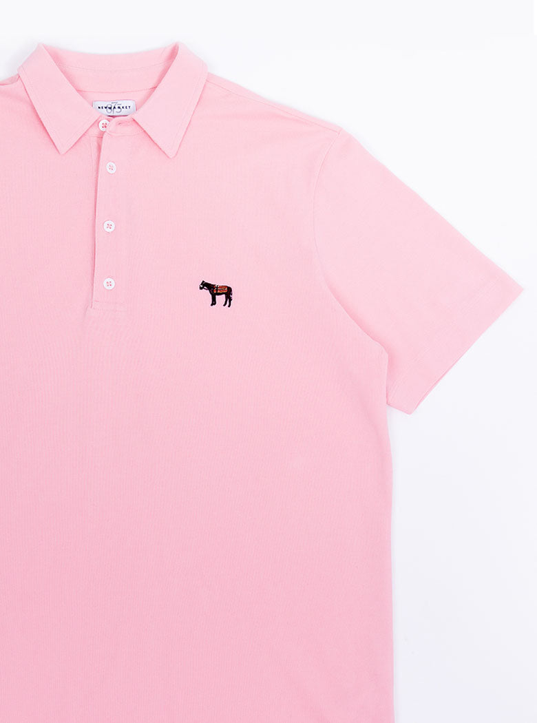 Flat lay of men's pale pink polo shirt in 100% cotton with Newmarket 875 horse logo embroidered on the front.