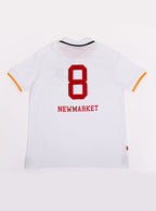 Flat lay of men's white polo shirt in 100% cotton with Newmarket 875 crest embroidered on the front and giant red 8 on the back with navy sleeve trimming and gold collar trimming.