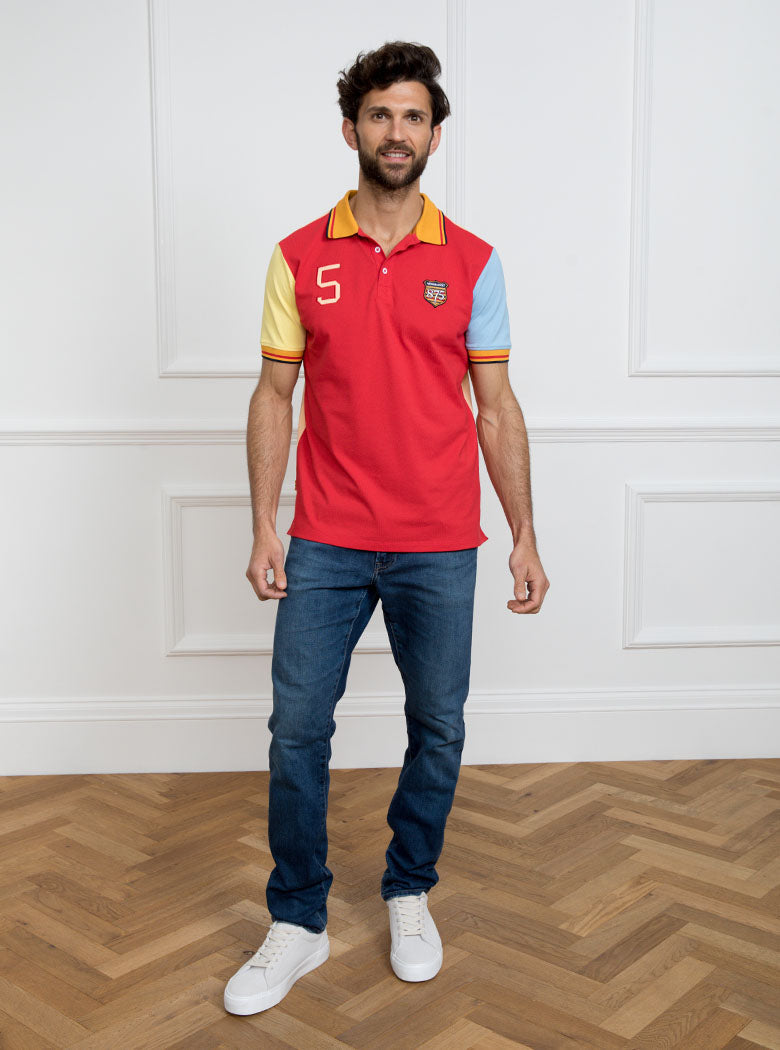 Man wearing multicoloured polo shirt with giant number 5 on the back, made of 100% cotton.