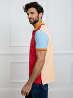 Man wearing multicoloured polo shirt with giant number 5 on the back, made of 100% cotton.