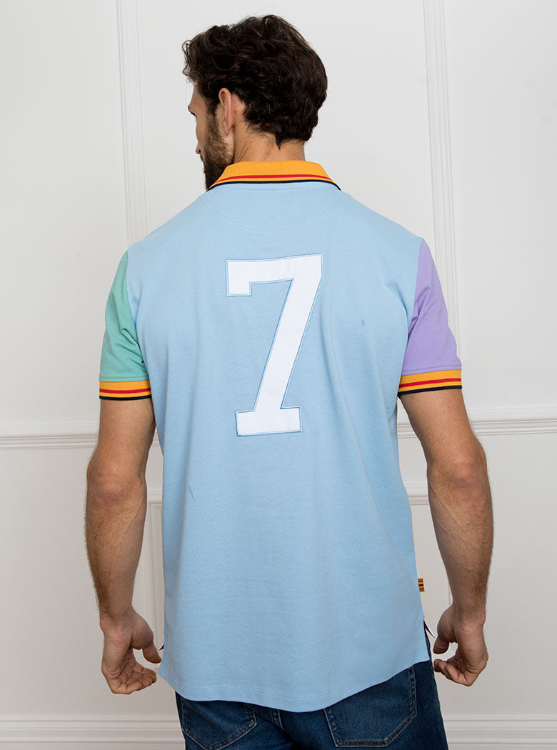 Man wearing multicoloured polo shirt with newmarket 875 crest on the front and number 7 on the back, made of 100% cotton.