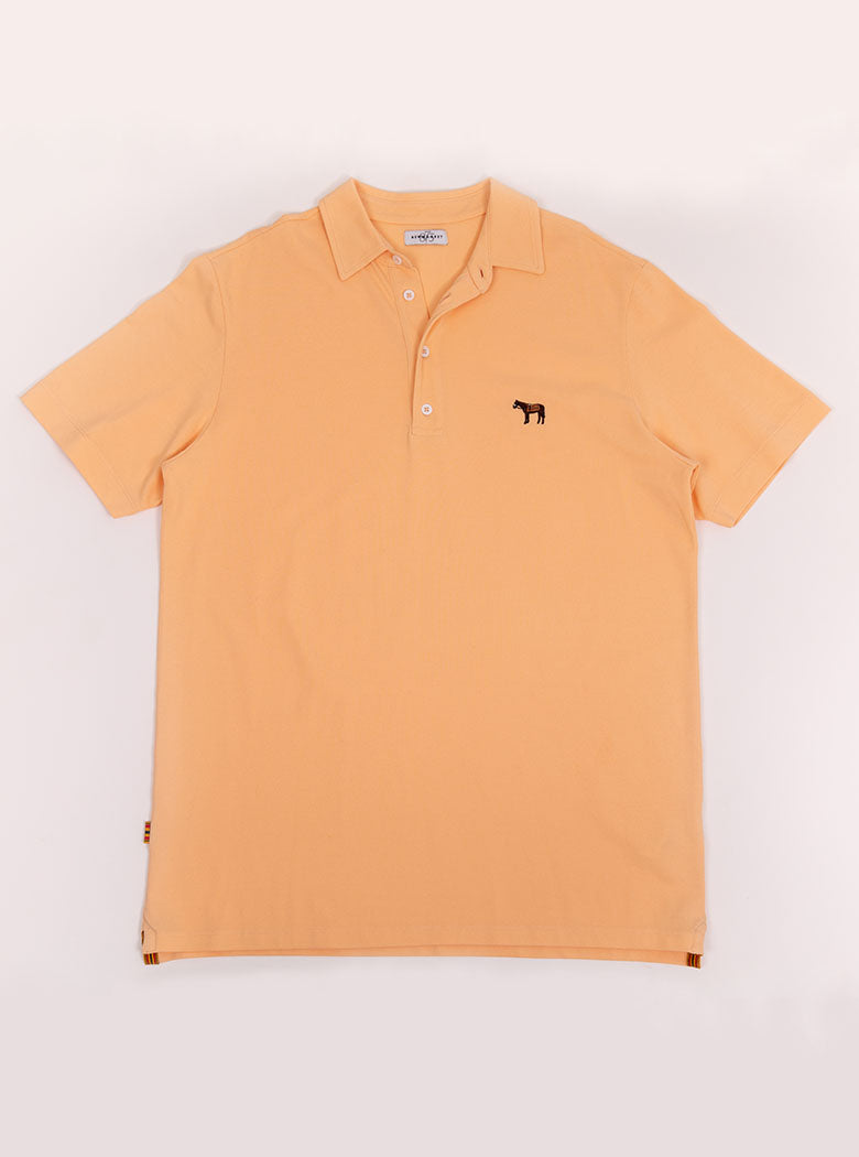 Flat lay of men's peach coloured polo shirt in 100% cotton with Newmarket 875 horse logo embroidered on the front.