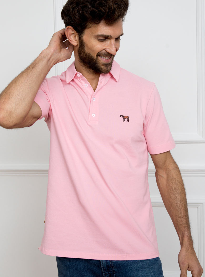 Man wearing pale pink polo shirt in 100% cotton with Newmarket 875 horse logo embroidered on the front.