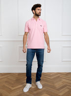 Man wearing pale pink polo shirt in 100% cotton with Newmarket 875 horse logo embroidered on the front.