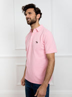 Man wearing pale pink polo shirt in 100% cotton with Newmarket 875 horse logo embroidered on the front.