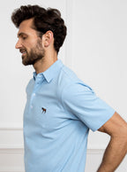 Man wearing sky blue polo shirt in 100% cotton with Newmarket 875 horse logo embroidered on the front.