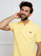Man wearing lemon yellow polo shirt in 100% cotton with Newmarket 875 horse logo embroidered on the front.