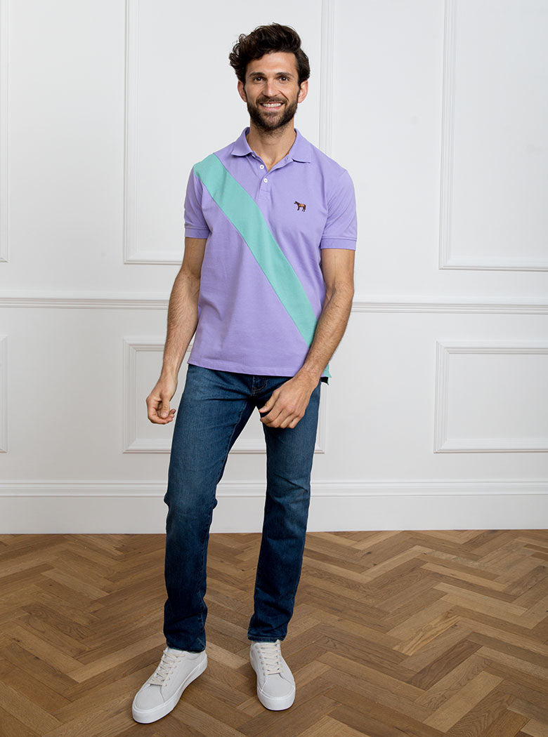 Man wearing lilac 100% cotton polo shirt with avocado green sash detail and Newmarket 875 horse logo embroidered on the front.