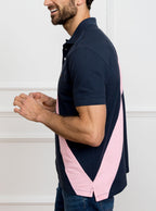 Man wearing navy 100% cotton polo shirt with pale pink sash detail and Newmarket 875 horse logo embroidered on the front.