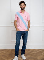 Man wearing pale pink 100% cotton polo shirt with sky blue sash detail and Newmarket 875 horse logo embroidered on the front.