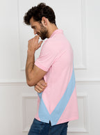 Man wearing pale pink 100% cotton polo shirt with sky blue sash detail and Newmarket 875 horse logo embroidered on the front.