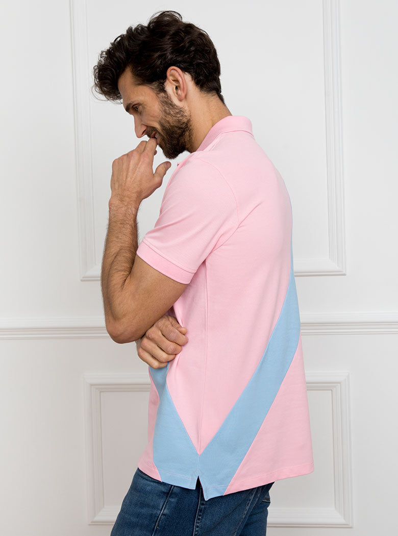 Man wearing pale pink 100% cotton polo shirt with sky blue sash detail and Newmarket 875 horse logo embroidered on the front.