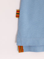 Close up flat lay of mens 100% cotton polo in a sky blue colour with the Newmarket 875 brand tag.
