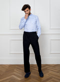 Man wearing a sky blue long sleeved shirt with a button down collar made with 100% Royal Oxford Cotton.
