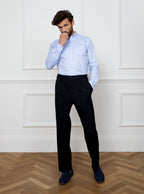 Man wearing a sky blue long sleeved shirt with a button down collar made with 100% Royal Oxford Cotton.