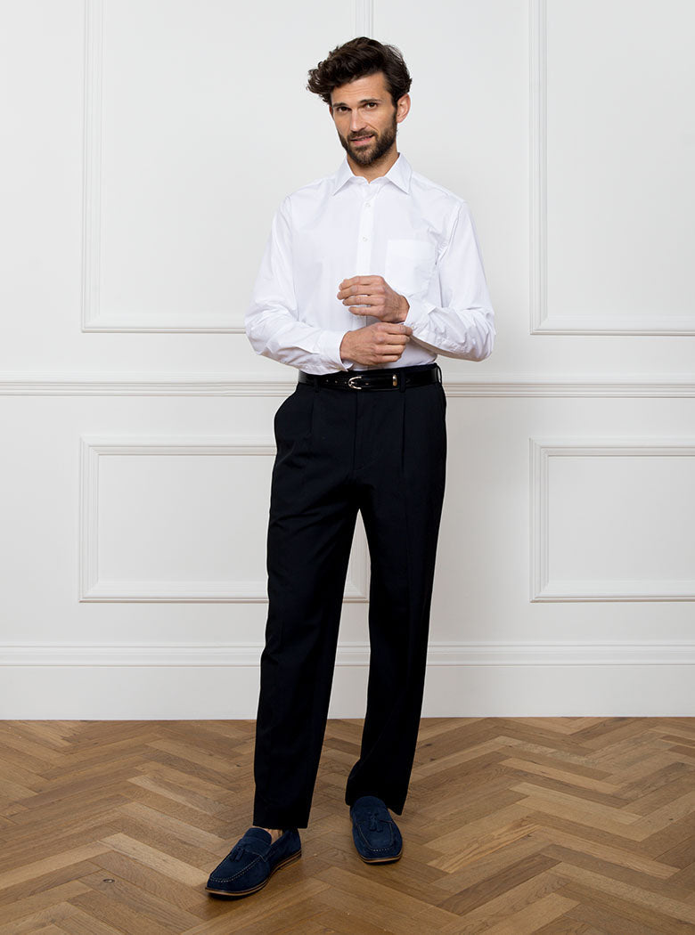 Man wearing white long sleeved shirt made with 100% Royal Oxford Cotton.