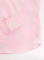 Flat lay of men's long sleeved shirt with pale pink thin stripe and gingham cuff and collar pattern on the inside. Made with 100% cotton in Thomas Mason fabric.
