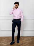 Man wearing a pale pink long sleeved shirt in a gingham pattern made with 100% cotton in a Thomas Mason fabric.