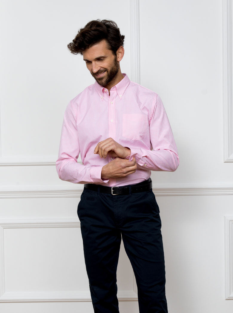 Man wearing a pale pink long sleeved shirt in a gingham pattern made with 100% cotton in a Thomas Mason fabric.