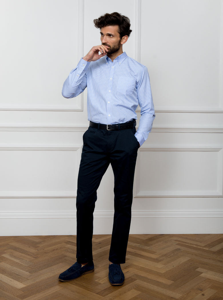 Man wearing sky blue long sleeved shirt in a gingham pattern made with 100% cotton in a Thomas Mason fabric.