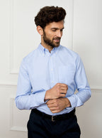 Man wearing sky blue long sleeved shirt in a gingham pattern made with 100% cotton in a Thomas Mason fabric.