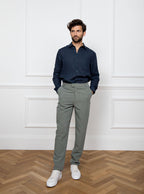 Man wearing a navy blue long sleeved shirt with pocket detail made with 100% linen in a Thomas Mason fabric.