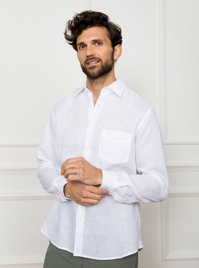 Man wearing white long sleeved shirt with a pocket detail made with 100% linen in a Thomas Mason fabric.