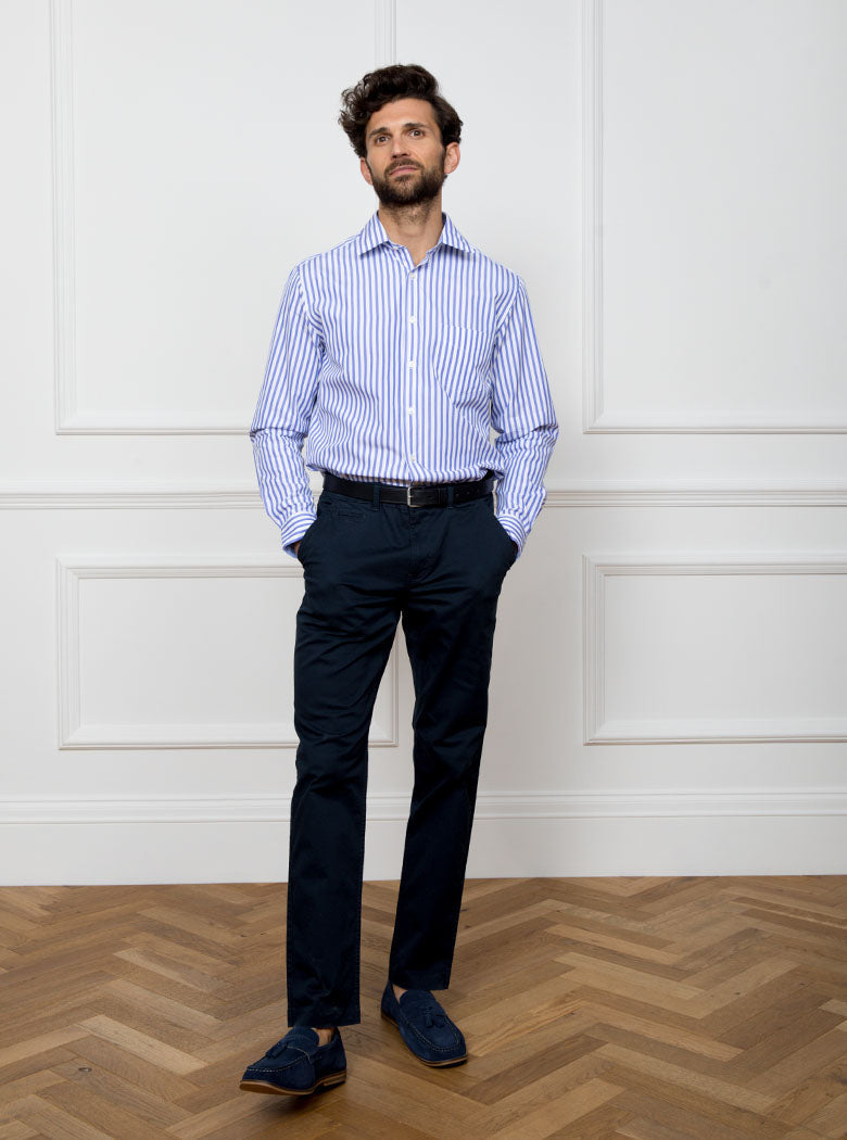 Man wearing long sleeved shirt with royal blue and white stripe. Made with 100% cotton in Thomas Mason fabric.