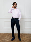 Man wearing long sleeved shirt with pale pink and white stripe made with 100% cotton from Thomas Mason.