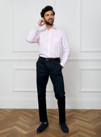 Man wearing long sleeved shirt with pale pink and white stripe made with 100% cotton from Thomas Mason.