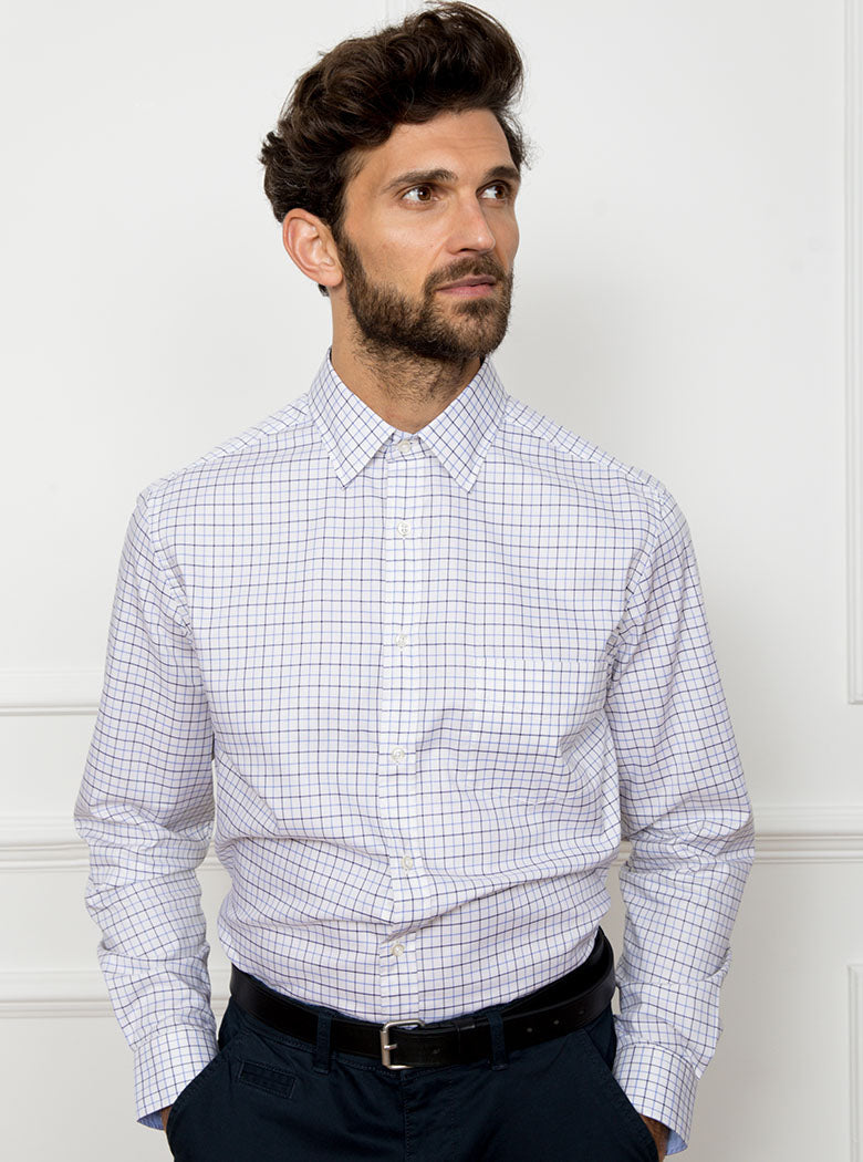 Man wearing long sleeved shirt in a tattersall blue check pattern design with premium and luxury cotton in Thomas Mason fabric.