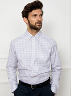 Man wearing long sleeved shirt in a tattersall blue check pattern design with premium and luxury cotton in Thomas Mason fabric.
