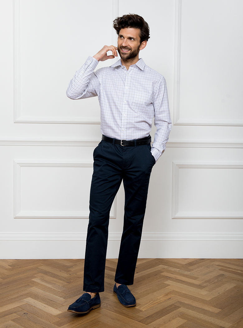Man wearing long sleeved shirt in a tattersall blue check pattern design with premium and luxury cotton in Thomas Mason fabric.