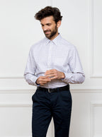 Man wearing long sleeved shirt in a tattersall blue check pattern design with premium and luxury cotton in Thomas Mason fabric.