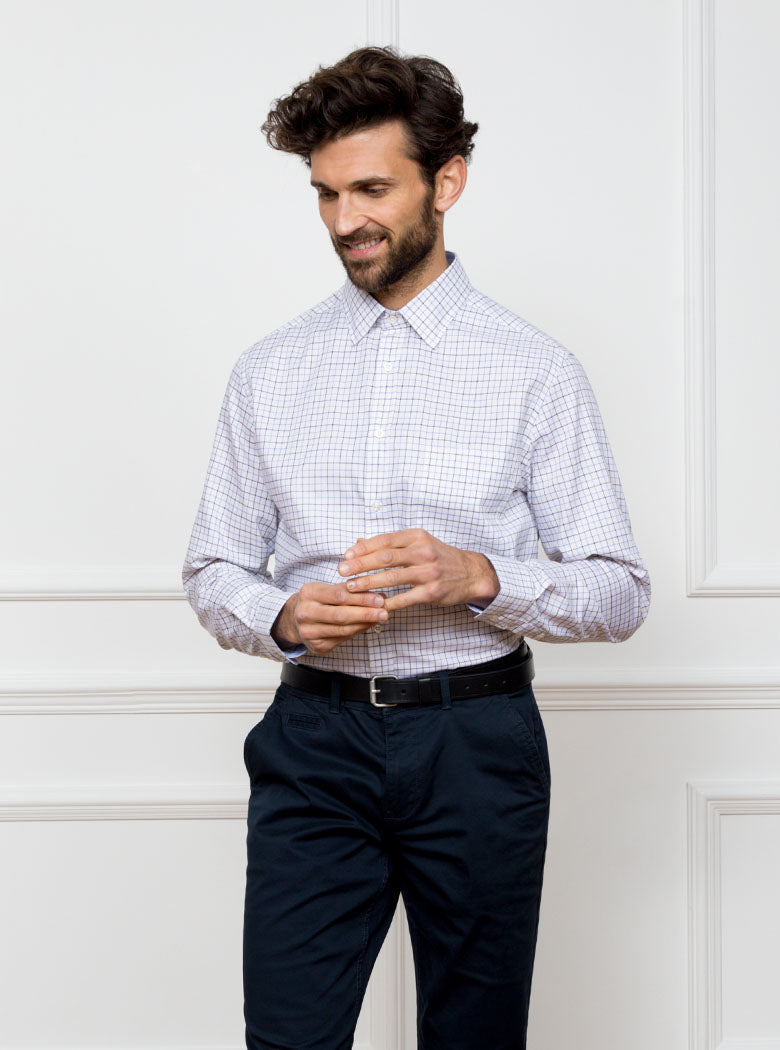 Man wearing long sleeved shirt in a tattersall blue check pattern design with premium and luxury cotton in Thomas Mason fabric.