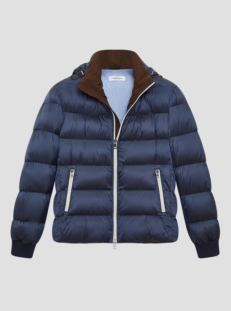 Navy gloss puffer jacket with brown suede lining on the inside collar with navy elasticated cuffs. Contrast pale grey zips and baby blue jacket lining. Detachable hood.