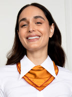 Woman wearing 100% silk 40x40 hank scarf in gold yellow with red hand stitched border. 